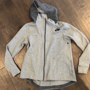 Nike like new zip up, high in the back lower front